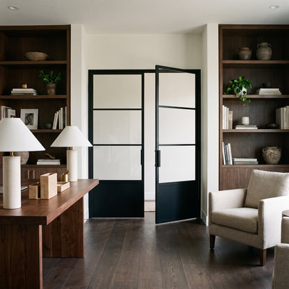 Modern home office featuring a Light 3 Interior double steel door with kickplate, elegantly framed by dark wood bookshelves.